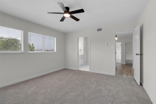 18010 Santolina Ln, Katy, TX 77449 - unfurnished bedroom with light colored carpet, baseboards, ensuite bath, and ceiling fan