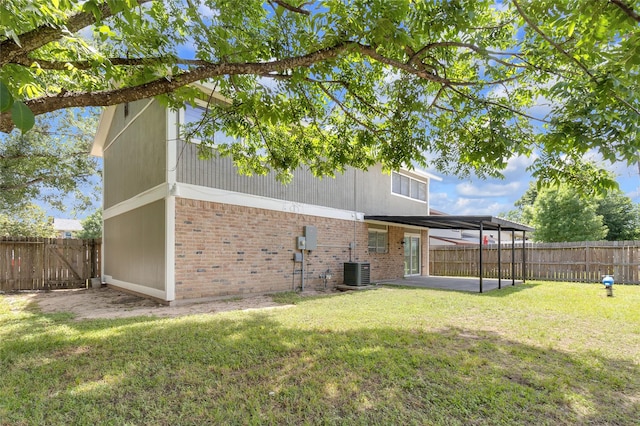 18010 Santolina Ln, Katy, TX 77449 - back of property featuring brick siding, a patio, and central AC