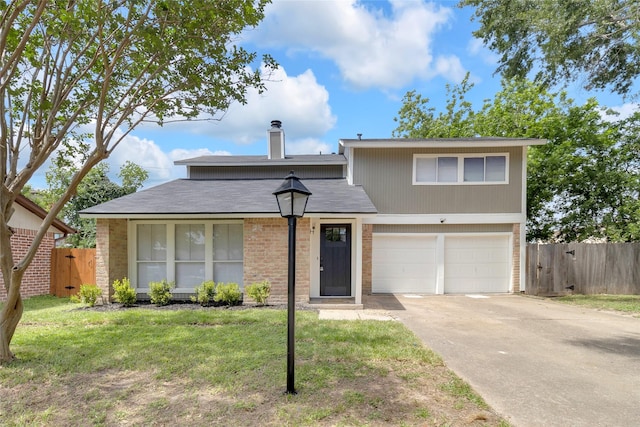 18010 Santolina Ln, Katy, TX 77449 - traditional home featuring a garage, concrete driveway, a chimney, and brick siding