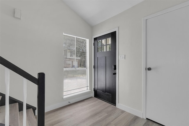 18010 Santolina Ln, Katy, TX 77449 - foyer with lofted ceiling, light wood-type flooring, baseboards, and stairway