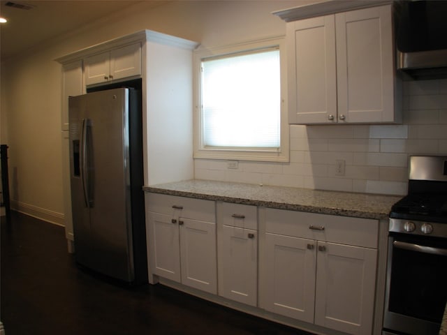 2405 Keene St, Houston, TX 77009 - kitchen with appliances with stainless steel finishes, backsplash, light stone countertops, and range hood