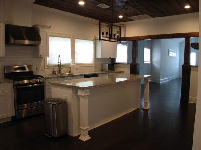 2405 Keene St, Houston, TX 77009 - kitchen featuring appliances with stainless steel finishes, range hood, wooden ceiling, a sink, and white cabinetry