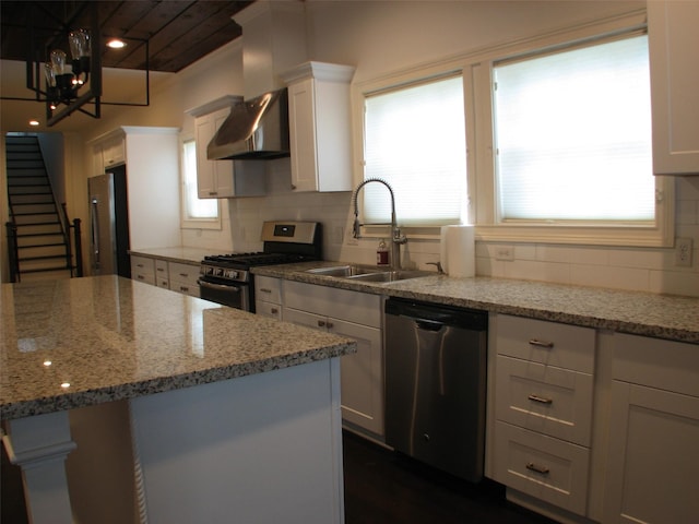 2405 Keene St, Houston, TX 77009 - kitchen featuring stainless steel appliances, exhaust hood, a sink, white cabinets, and backsplash