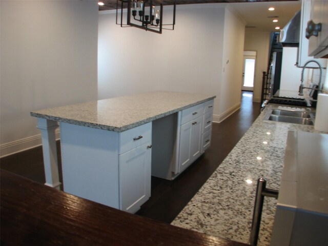 2405 Keene St, Houston, TX 77009 - kitchen with baseboards, a chandelier, white cabinetry, dark wood finished floors, and recessed lighting