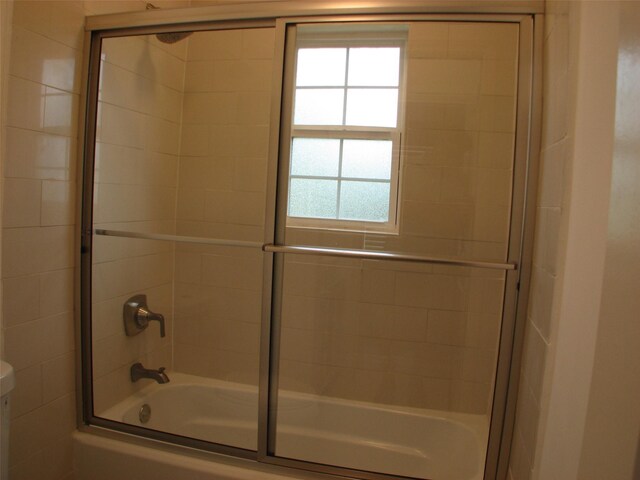 2405 Keene St, Houston, TX 77009 - full bath with bath / shower combo with glass door, healthy amount of natural light, and toilet