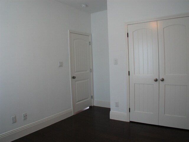 2405 Keene St, Houston, TX 77009 - unfurnished bedroom with baseboards, a closet, and dark wood finished floors