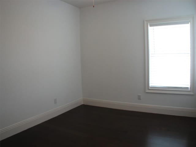 2405 Keene St, Houston, TX 77009 - unfurnished room with healthy amount of natural light, baseboards, and dark wood-type flooring