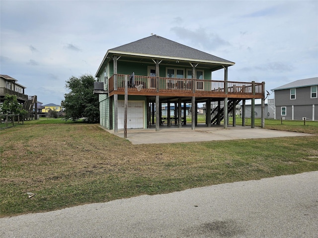 970 Olive Dr, Crystal Beach, TX 77650 - rear view of property featuring a yard, a carport, an attached garage, stairs, and driveway