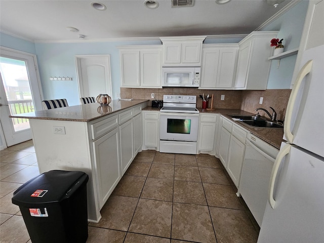970 Olive Dr, Crystal Beach, TX 77650 - kitchen with white appliances, a peninsula, open shelves, a sink, and white cabinetry