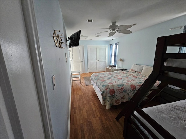 970 Olive Dr, Crystal Beach, TX 77650 - bedroom featuring wood finished floors, a closet, and ceiling fan