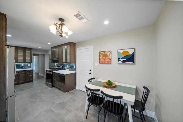 4266 T C Jester Blvd, Houston, TX 77018 - kitchen featuring electric range, freestanding refrigerator, decorative backsplash, light countertops, and recessed lighting