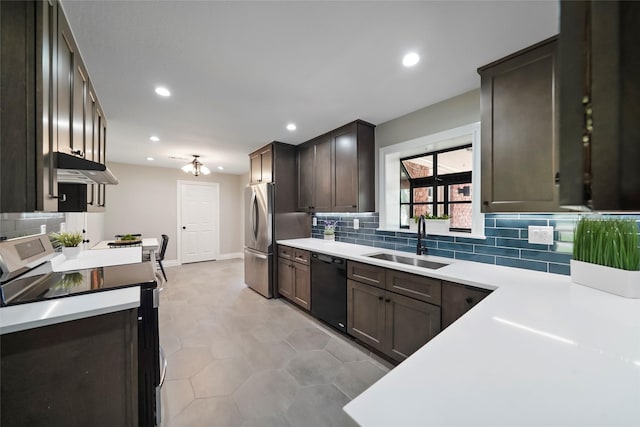 4266 T C Jester Blvd, Houston, TX 77018 - kitchen featuring appliances with stainless steel finishes, a sink, under cabinet range hood, light countertops, and recessed lighting