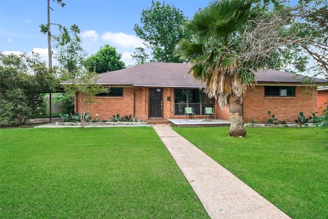 4266 T C Jester Blvd, Houston, TX 77018 - ranch-style home featuring brick siding, a front yard, and covered porch
