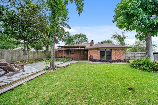4266 T C Jester Blvd, Houston, TX 77018 - back of property with brick siding, a chimney, a deck, and a patio