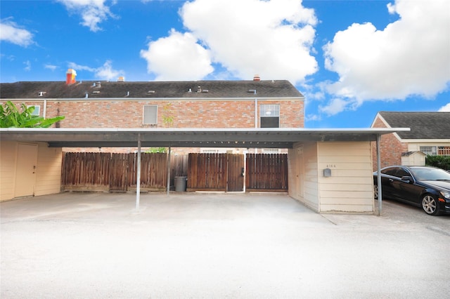 4164 Belle Park Dr Unit 4164, Houston, TX 77072 - rear view of property with covered parking, fence, and brick siding