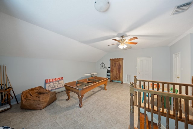 interior space with a ceiling fan, vaulted ceiling, baseboards, and light flooring
