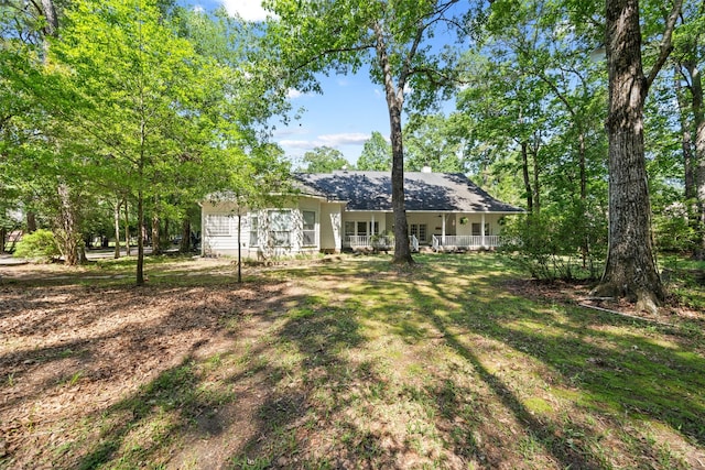 rear view of property featuring a porch