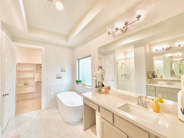 7014 Anacua Berry Cir, Katy, TX 77493 - bathroom with a stall shower, a freestanding bath, marble look tile flooring, a spacious closet, and a raised ceiling