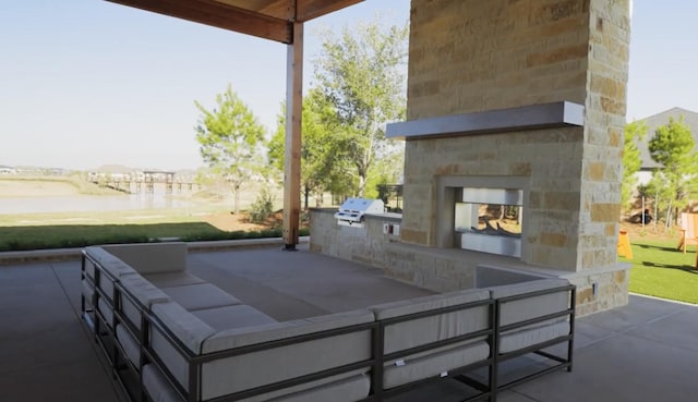 7014 Anacua Berry Cir, Katy, TX 77493 - view of patio / terrace featuring an outdoor stone fireplace, area for grilling, a grill, and a water view