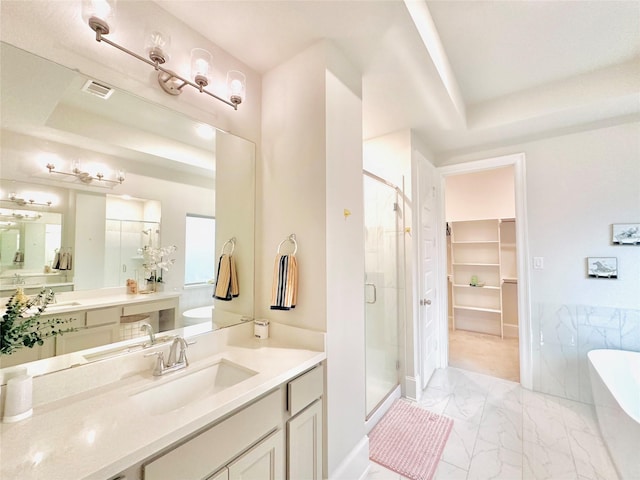 7014 Anacua Berry Cir, Katy, TX 77493 - full bath featuring a stall shower, a raised ceiling, marble finish flooring, a freestanding tub, and a spacious closet