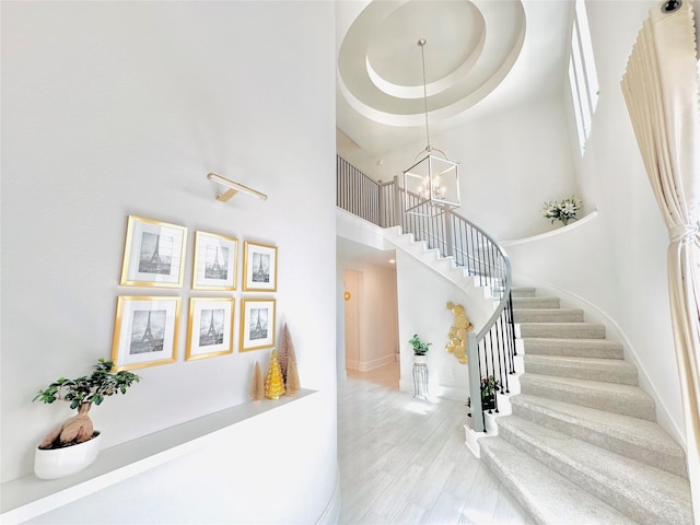 7014 Anacua Berry Cir, Katy, TX 77493 - stairway featuring a high ceiling, a chandelier, and baseboards