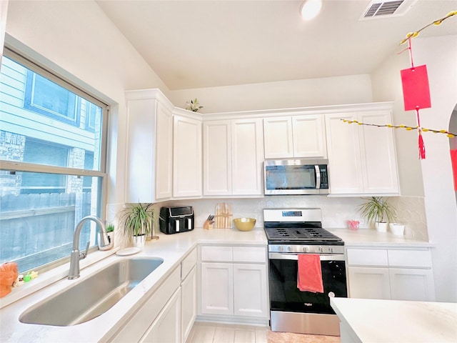 7014 Anacua Berry Cir, Katy, TX 77493 - kitchen with stainless steel appliances, a sink, and white cabinets
