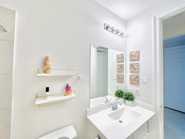 7014 Anacua Berry Cir, Katy, TX 77493 - half bathroom with toilet, vanity, and wood finished floors
