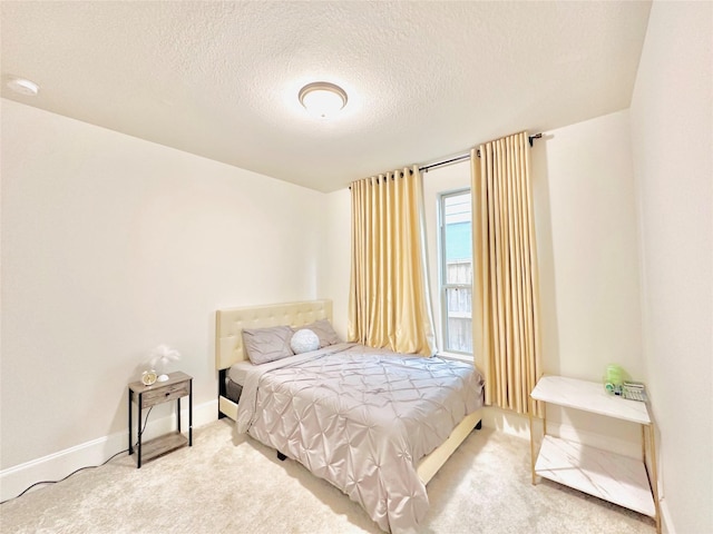 7014 Anacua Berry Cir, Katy, TX 77493 - bedroom featuring carpet floors, a textured ceiling, and baseboards