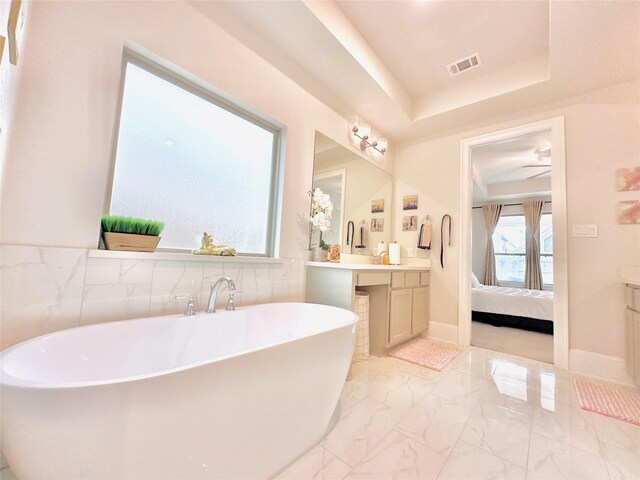 7014 Anacua Berry Cir, Katy, TX 77493 - bathroom with marble finish floors, vanity, ensuite bathroom, and a freestanding tub