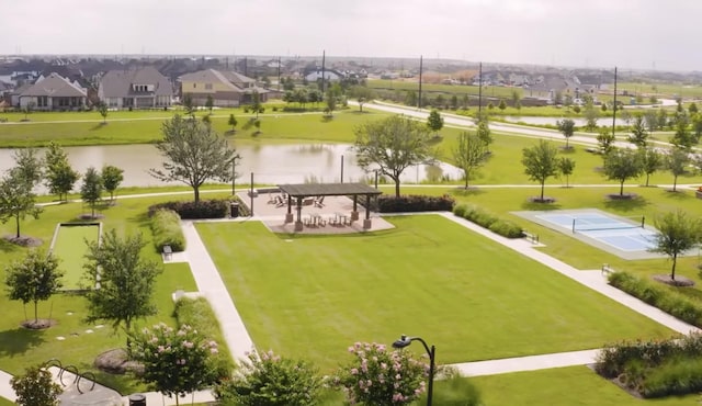 7014 Anacua Berry Cir, Katy, TX 77493 - surrounding community with shuffleboard, a water view, and a lawn