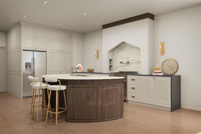 1202 Aurora St, Houston, TX 77009 - kitchen featuring fridge with ice dispenser, high end stainless steel range oven, light wood-style floors, white cabinets, and recessed lighting