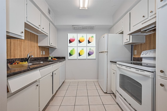 2250 Bering Dr Unit 101, Houston, TX 77057 - kitchen featuring white appliances, under cabinet range hood, white cabinetry, and light tile patterned floors
