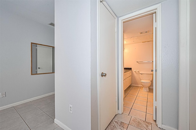 2250 Bering Dr Unit 101, Houston, TX 77057 - hall with light tile patterned floors and baseboards