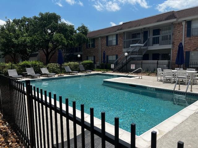 2250 Bering Dr Unit 101, Houston, TX 77057 - community pool featuring fence, a patio area, and stairs