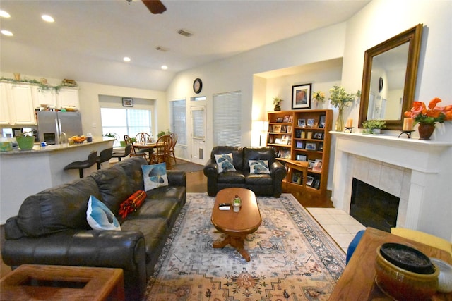 20815 Crimson Oak Trl, Humble, TX 77346 - living area featuring recessed lighting, vaulted ceiling, wood finished floors, and a tiled fireplace