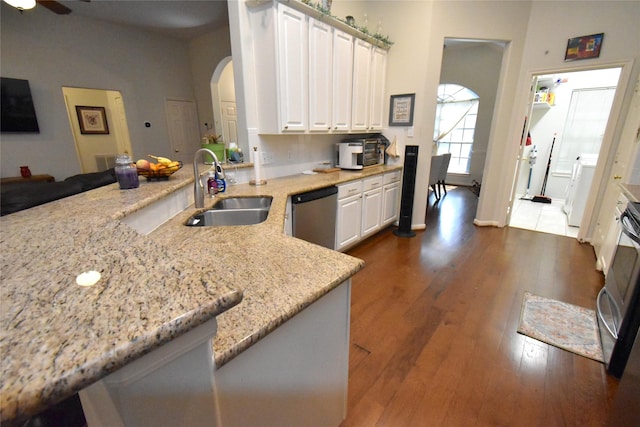 20815 Crimson Oak Trl, Humble, TX 77346 - kitchen featuring a sink, dishwasher, arched walkways, a ceiling fan, and dark wood-style floors