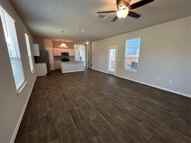2002 Arborside Dr, Austin, TX 78754 - unfurnished living room with dark wood-style floors, ceiling fan, and baseboards