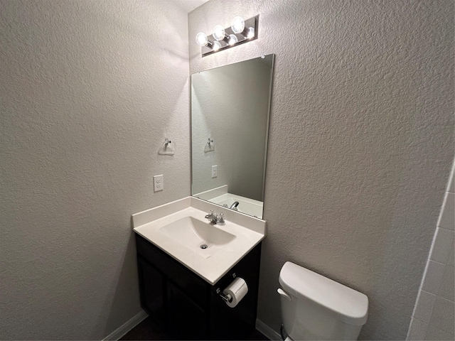 2002 Arborside Dr, Austin, TX 78754 - half bathroom featuring toilet, vanity, and a textured wall