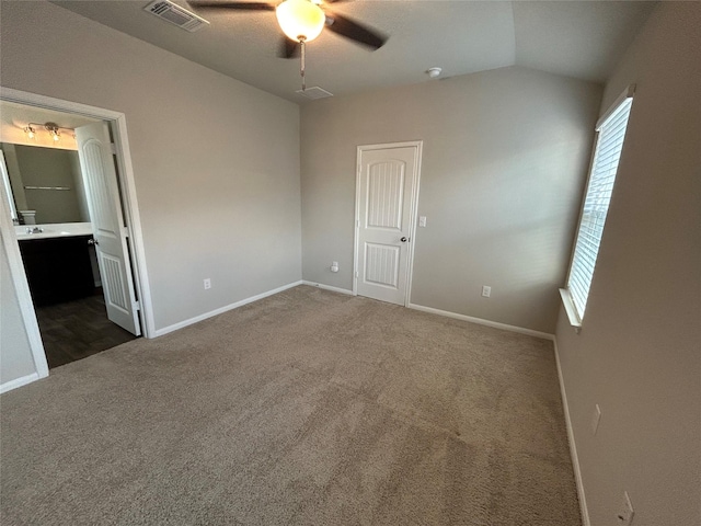 2002 Arborside Dr, Austin, TX 78754 - unfurnished bedroom with dark colored carpet, baseboards, ensuite bath, ceiling fan, and lofted ceiling