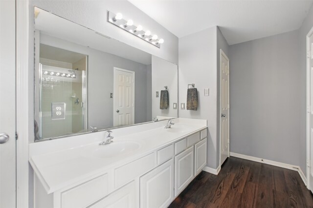 1193 Stallion Rdg, Alvin, TX 77511 - bathroom with wood finished floors, a shower with door, baseboards, and double vanity