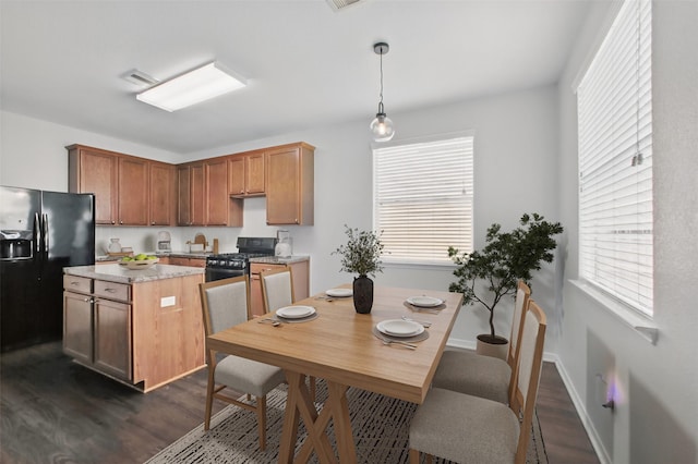 1193 Stallion Rdg, Alvin, TX 77511 - kitchen with black refrigerator with ice dispenser, gas range, dark wood-style floors, a kitchen island, and plenty of natural light