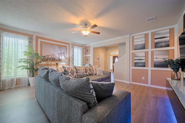 8113 E Pine Creek Bnd, Cypress, TX 77433 - living area featuring a ceiling fan and wood finished floors
