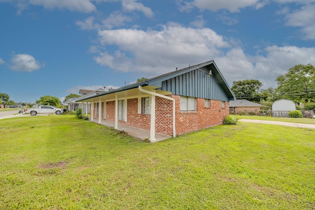 722 Dell Dale St, Channelview, TX 77530 - view of property exterior with brick siding, board and batten siding, and a lawn