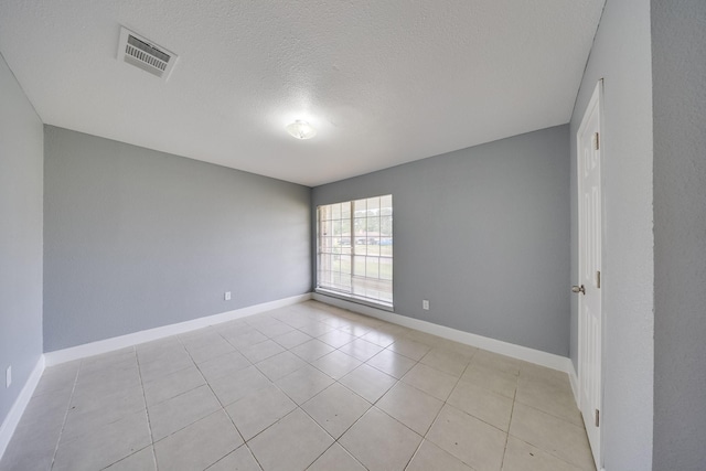 722 Dell Dale St, Channelview, TX 77530 - spare room featuring baseboards, a textured ceiling, and light tile patterned floors