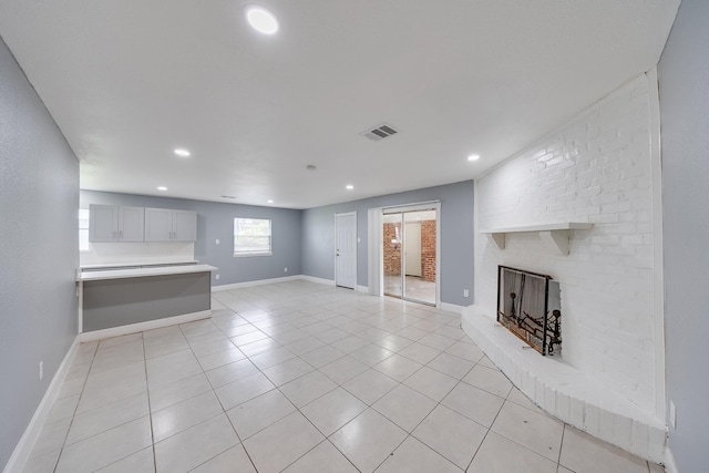 722 Dell Dale St, Channelview, TX 77530 - unfurnished living room with a brick fireplace, light tile patterned floors, recessed lighting, and baseboards