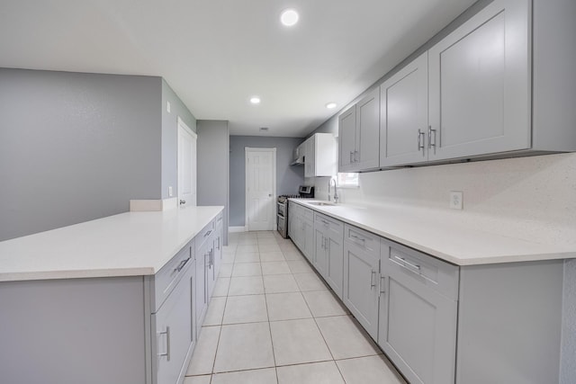722 Dell Dale St, Channelview, TX 77530 - kitchen with gas range, gray cabinets, light countertops, a sink, and recessed lighting