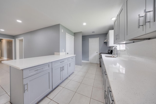 722 Dell Dale St, Channelview, TX 77530 - kitchen featuring recessed lighting, light countertops, stainless steel gas range, a sink, and light tile patterned floors