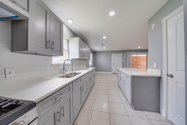 722 Dell Dale St, Channelview, TX 77530 - kitchen with a sink, light countertops, recessed lighting, light tile patterned floors, and gray cabinets