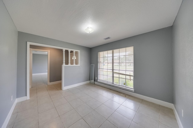 722 Dell Dale St, Channelview, TX 77530 - unfurnished room featuring a textured ceiling, baseboards, and light tile patterned floors