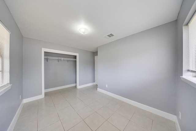 722 Dell Dale St, Channelview, TX 77530 - unfurnished bedroom with light tile patterned floors, a closet, and baseboards